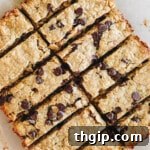 Baked and sliced high protein granola bars on parchment paper, ready to be enjoyed.