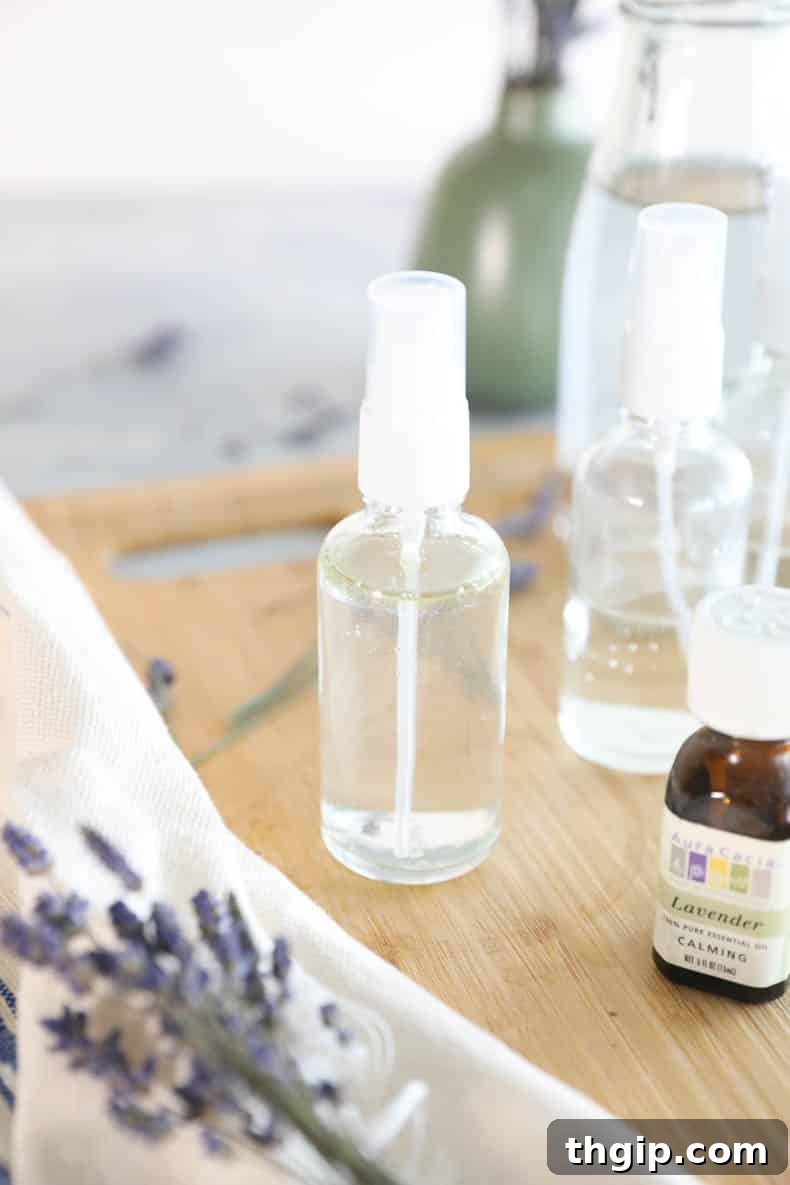 DIY Lavender Bliss Spray 6 Lavender essential oil being dropped into a clear glass spray bottle with witch hazel and water.