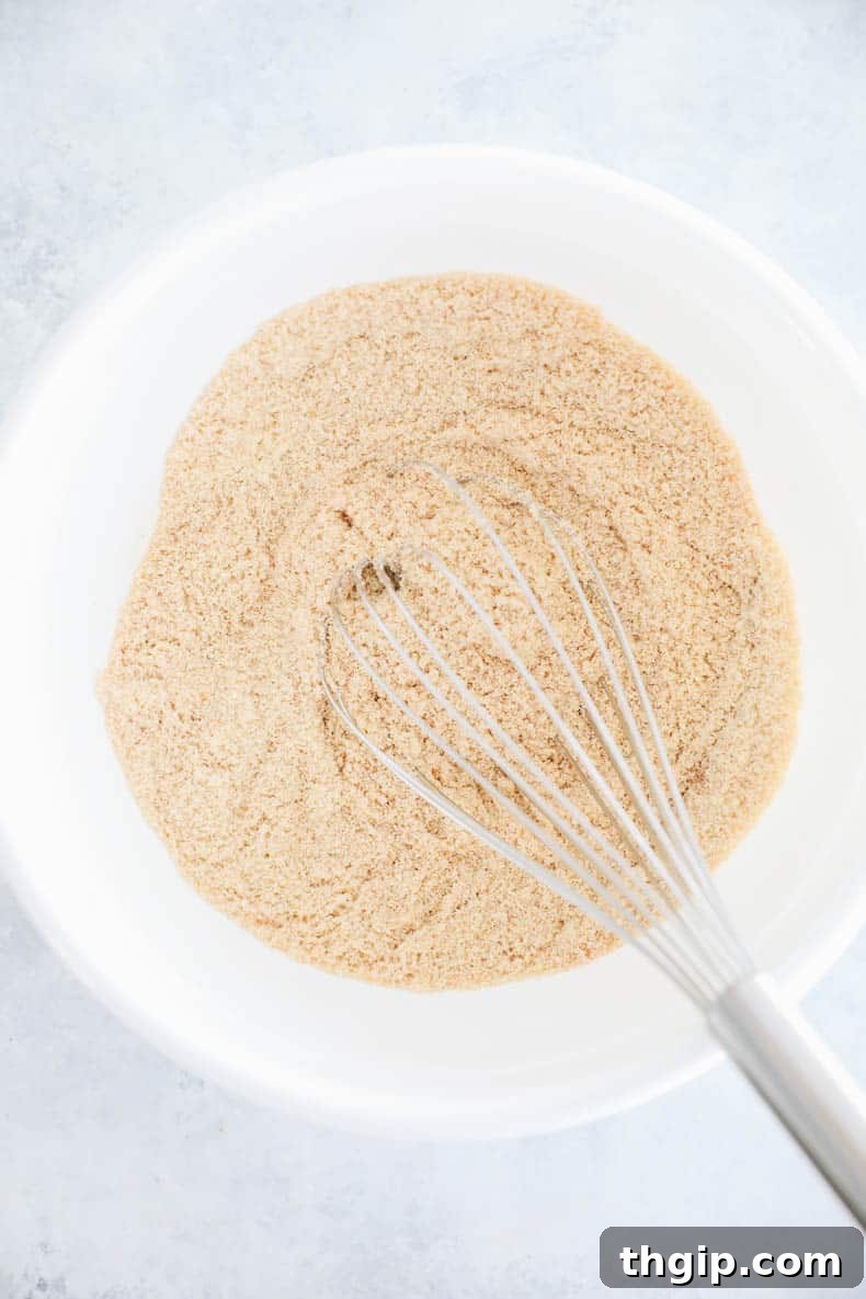 Dry ingredients for muffins being whisked in a bowl.