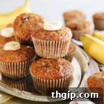 Almond flour banana muffins on a silver platter with sliced banana, ready to be served.
