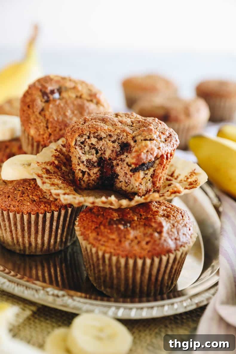 Several almond flour banana muffins arranged appealingly on a wooden surface.