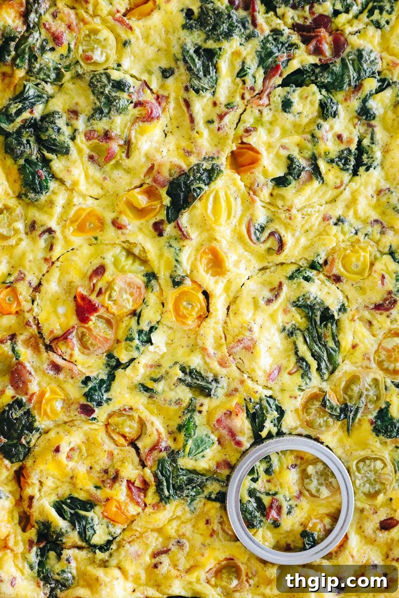 Sheet pan eggs with mason jar lid cut-outs for breakfast sandwiches.