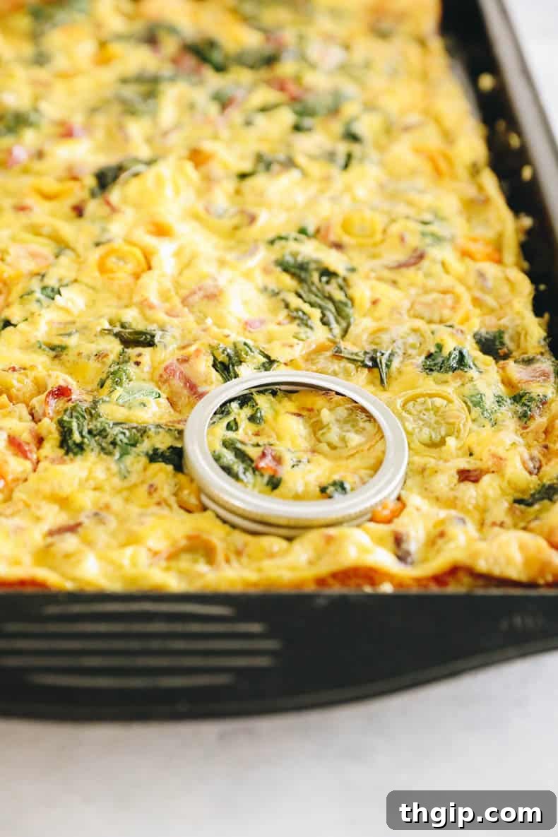 Baked egg slab on a sheet pan, perfectly set and ready for cutting.