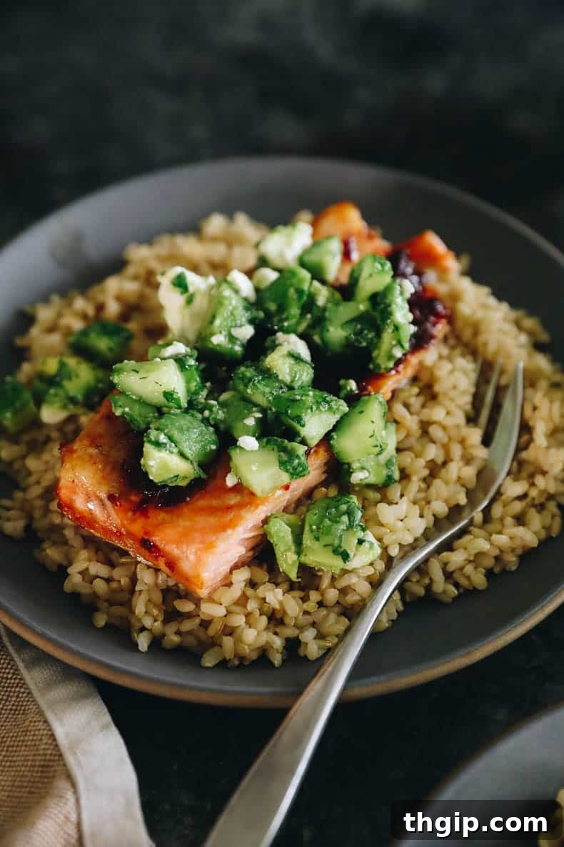 Chipotle salmon with rice and avocado cucumber salsa.