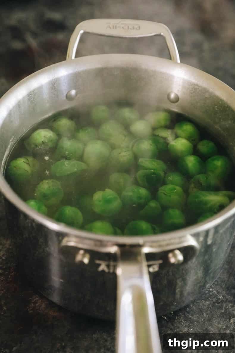 Golden Smashed Brussels Sprouts 3 Boiled brussel sprouts resting in a colander after being cooked.