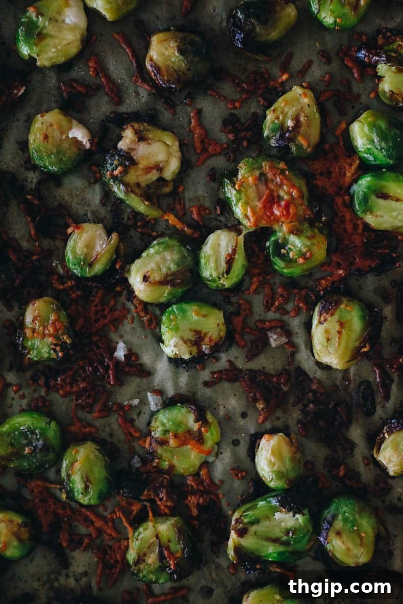 Golden Smashed Brussels Sprouts 5 Crispy smashed brussel sprouts with parmesan on a sheet pan, fresh out of the oven.
