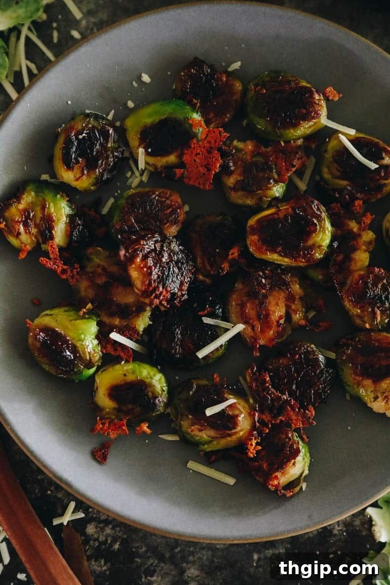 Golden Smashed Brussels Sprouts 8 A close-up shot of an entire serving of crispy smashed brussel sprouts on a blue plate.