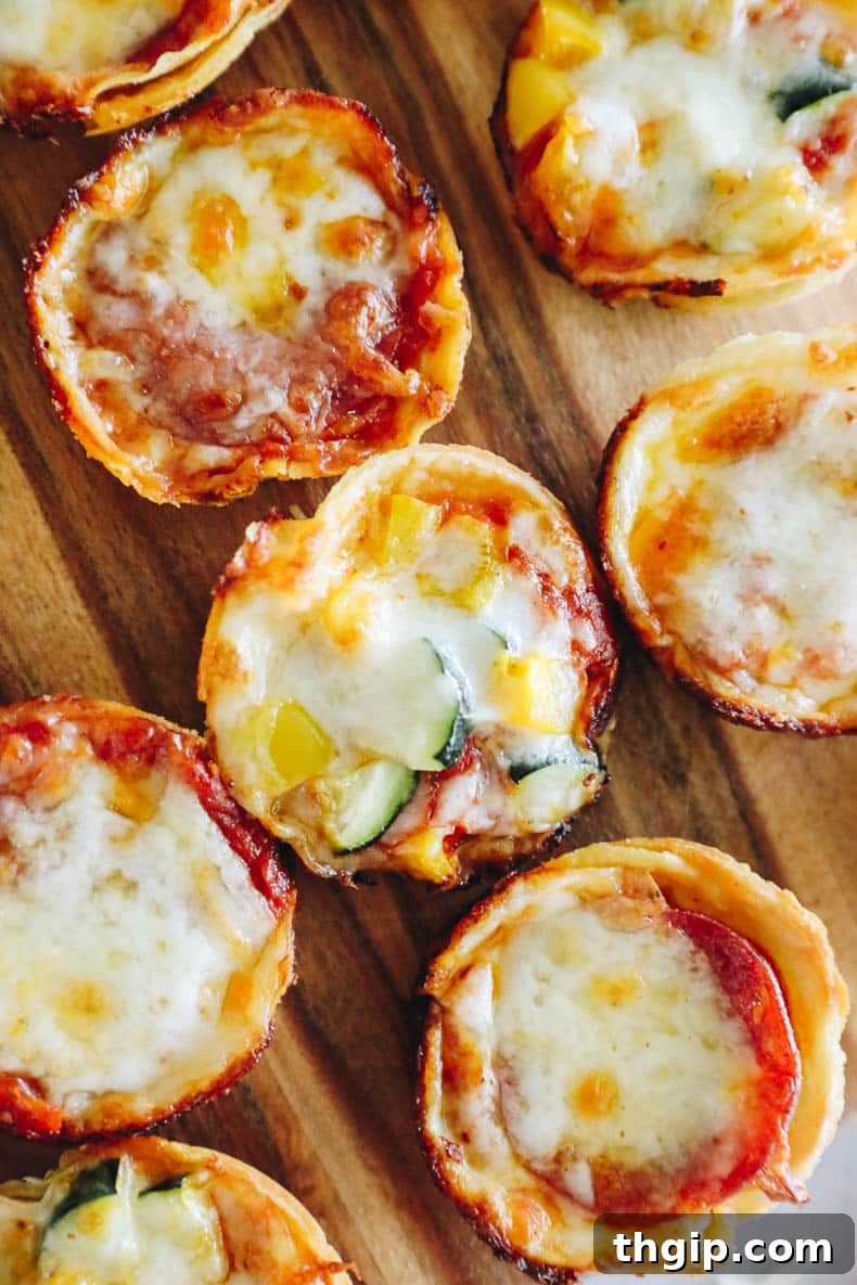 Close-up of a mini tortilla pizza cup with a mix of fresh vegetable toppings, including bell peppers and herbs, showcasing its vibrant colors and delicious potential.