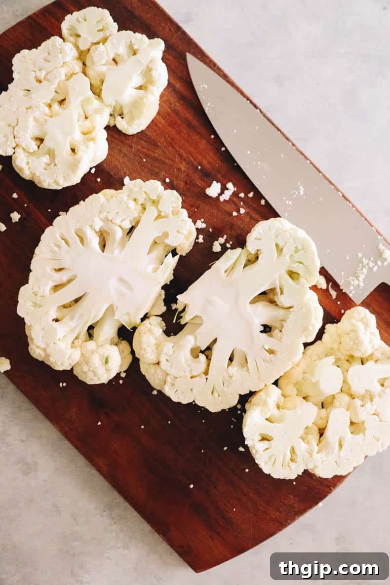 Golden Roasted Cauliflower Steaks 4 Close-up view of cauliflower steaks properly cut and laid out on a cutting board, showcasing their structure.