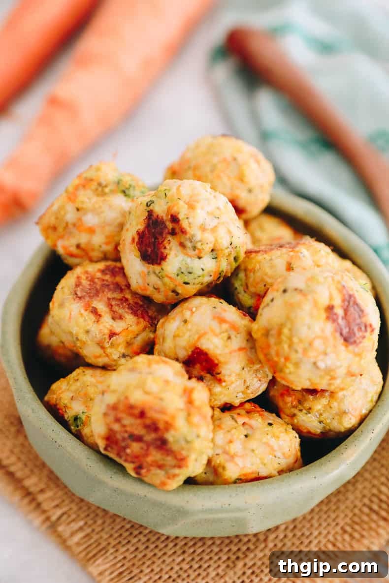 Kid-Approved Baked Chicken Meatballs with Secret Veggies 8 Close-up shot of baked chicken meatballs nestled in a green bowl, ready for enjoyment.