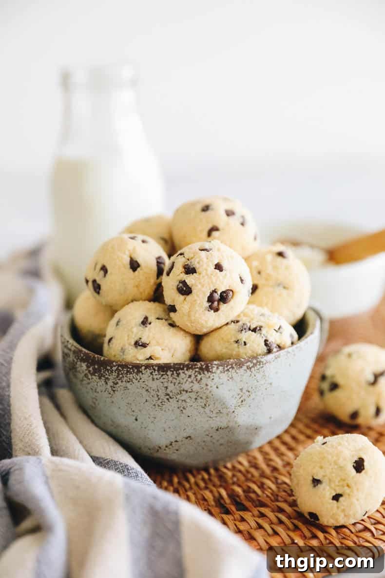 Protein cottage cheese cookie dough bites in a blue bowl, garnished with chocolate chips.