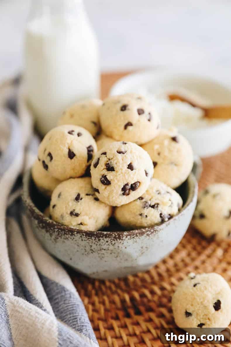 Cookie dough protein balls with chocolate chips in a blue bowl, ready for serving.