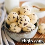 Cottage cheese cookie dough rolled into bite-sized balls with chocolate chips in a blue bowl.