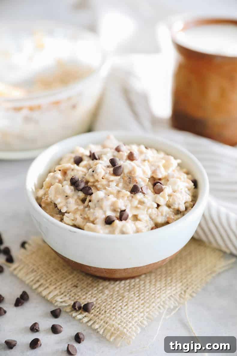 Creamy Cookie Dough Protein Overnight Oats 2 Creamy cottage cheese cookie dough overnight oats in a brown and white bowl, topped with chocolate chips and ready to eat.