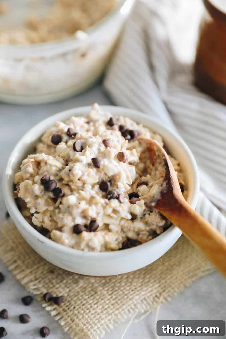 Creamy Cookie Dough Protein Overnight Oats 5 Close-up of cottage cheese cookie dough overnight oats with chocolate chips in a glass jar.