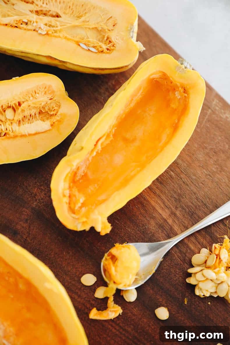 Hearty Farro-Filled Delicata Squash 3 Delicata squash halves with seeds removed, ready for roasting.