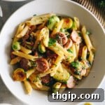 A bowl of freshly cooked Chicken Sausage Pasta, garnished with herbs.