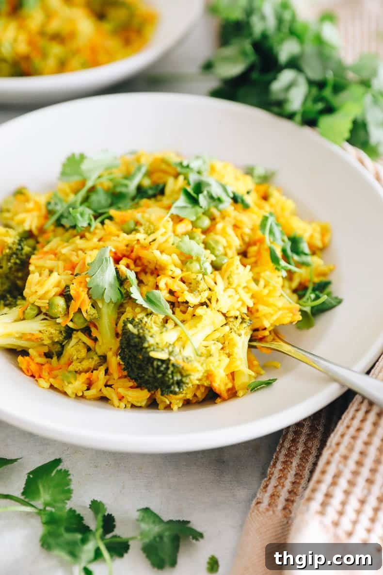 Fragrant Coconut Curry Rice with Vegetables 5 curry rice with broccoli and topped with cilantro in a white bowl.