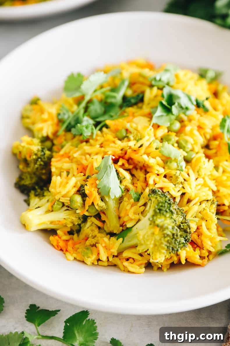 Fragrant Coconut Curry Rice with Vegetables 6 close up of curried rice with peas and cilantro.