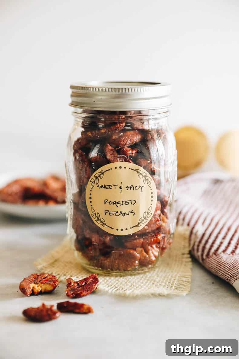 Candied Chili Pecans 6 A beautifully packaged mason jar of sweet and spicy roasted pecans, ready for gifting, featuring a rustic canning label.