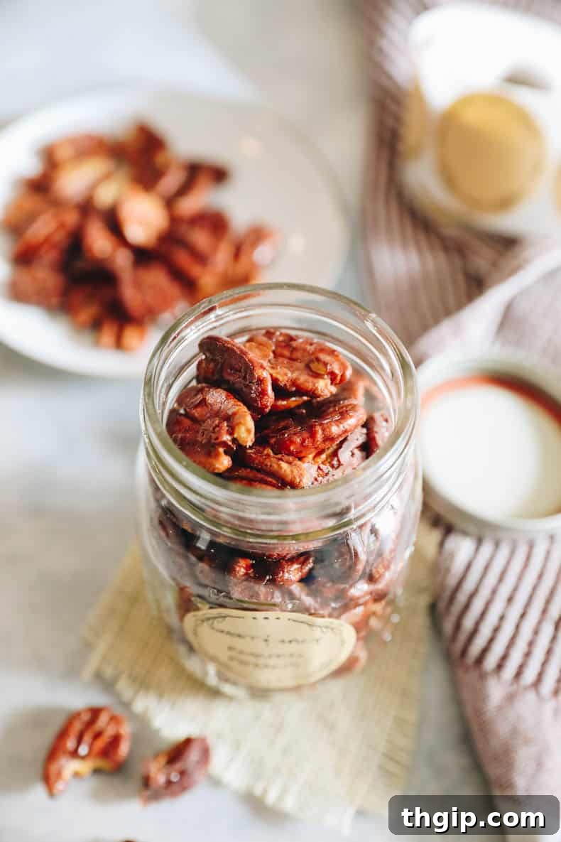 Candied Chili Pecans 8 A close-up of a rustic wooden surface with scattered sweet and spicy roasted pecans, highlighting their texture and glaze.
