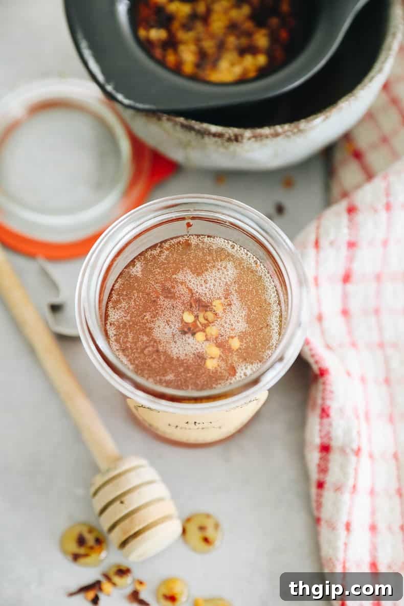 A series of images showing the step-by-step process of making hot honey, from heating ingredients to straining and storing the finished product.