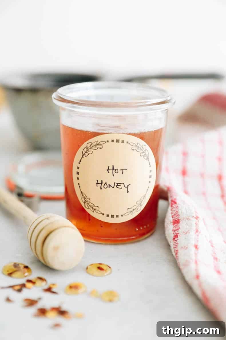 A beautifully composed shot of homemade hot honey in a jar, ready to be enjoyed.