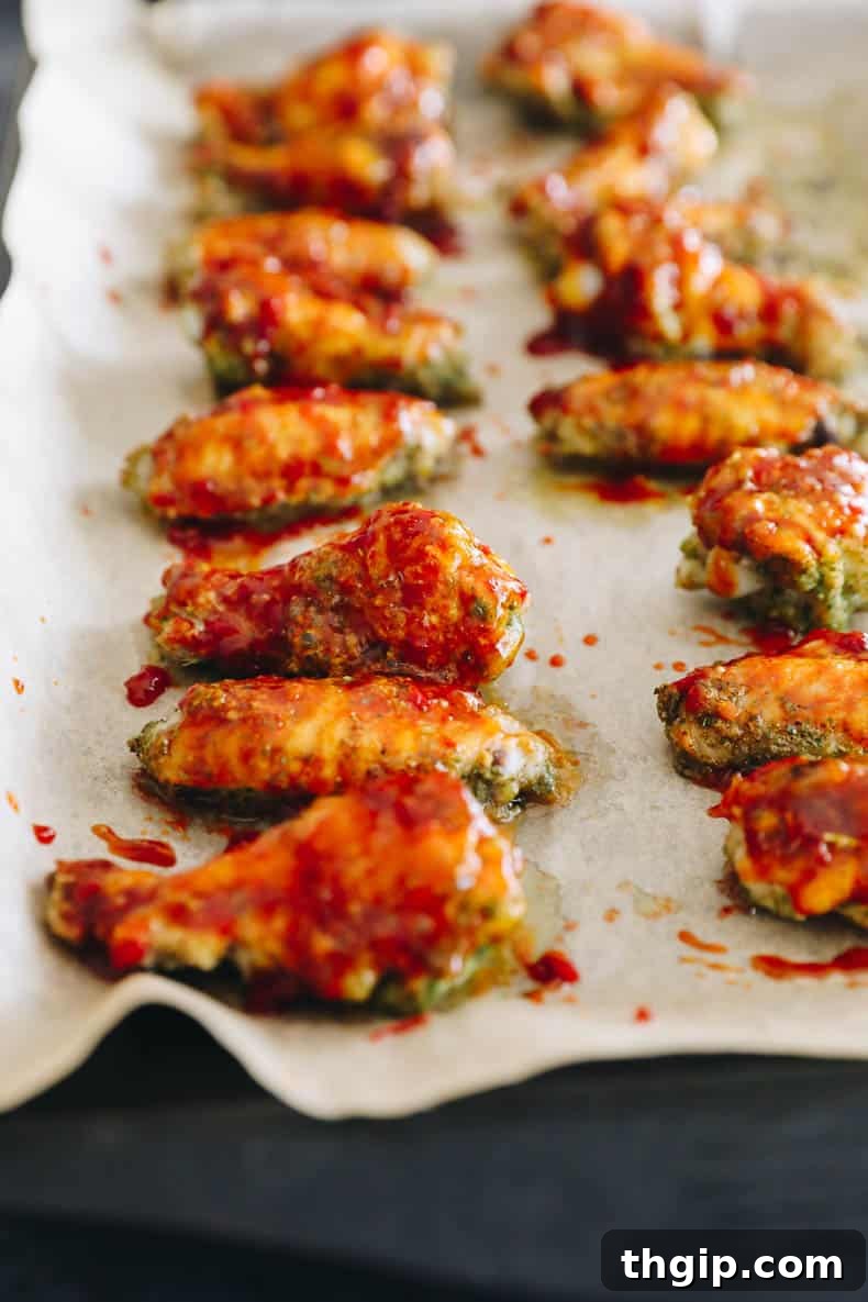 baked thai basil wings on a sheet pan lined with parchment.