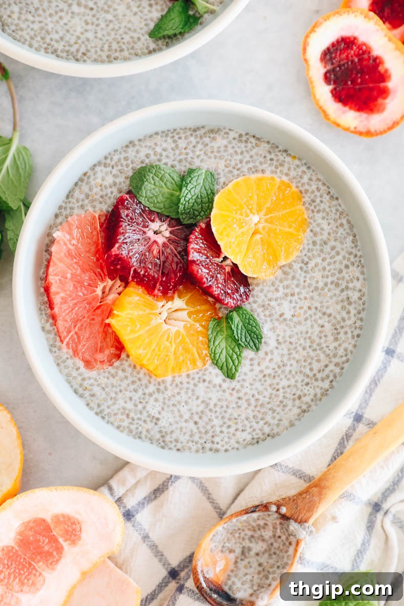 Sunshine Citrus Chia Pudding 2 Close up image of creamy chia pudding in a blue and white bowl, generously topped with ruby red grapefruit, vibrant blood orange slices, and sweet tangelo segments. A healthy, colorful winter dessert.