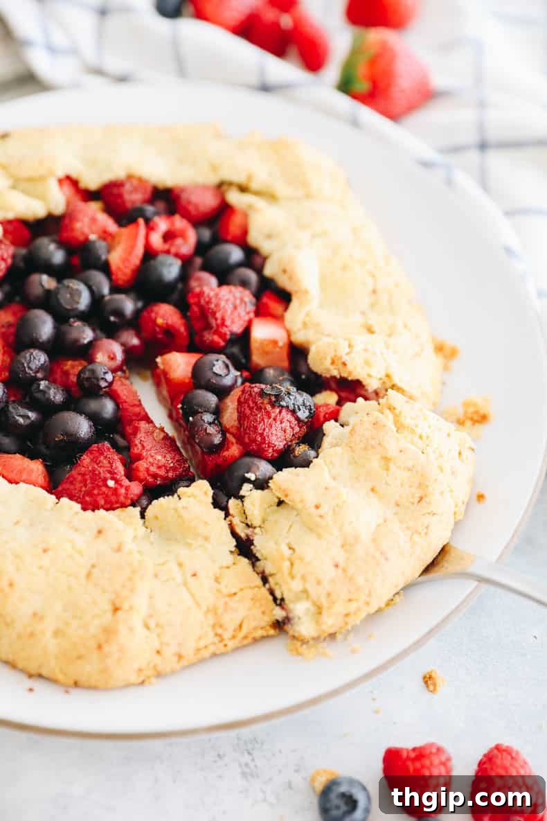 Berry Galette with Almond Flour Crust 11 Close-up of a slice of almond flour berry galette, showcasing the flaky crust and juicy berry filling.