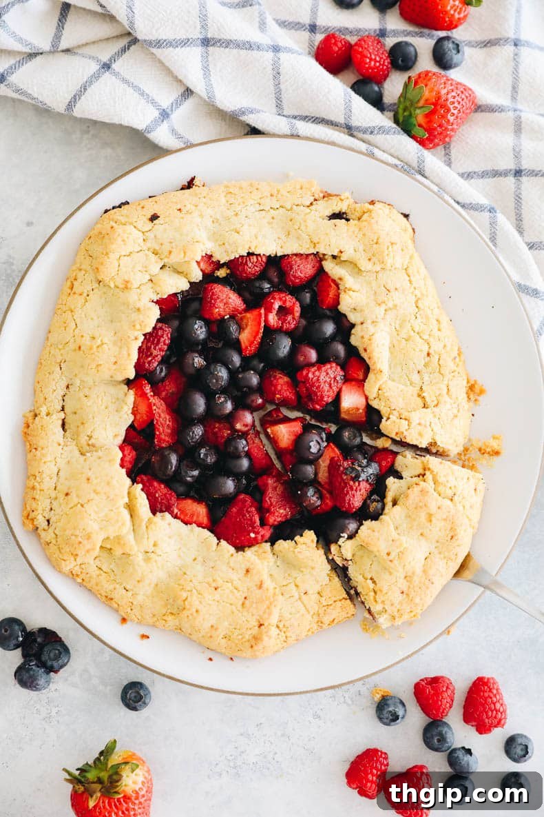 Berry Galette with Almond Flour Crust 13 Overhead image of a beautifully baked mixed berry almond flour galette, garnished and ready to serve.