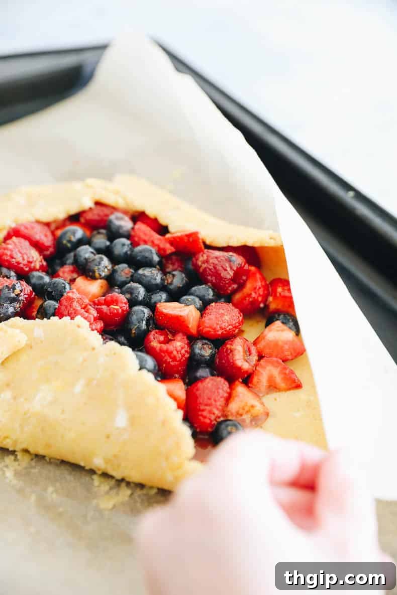 Berry Galette with Almond Flour Crust 8 Folding the edges of the almond flour crust over the berry filling to form a rustic galette.