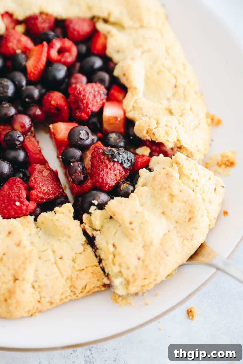 Berry Galette with Almond Flour Crust 10 Freshly baked almond flour berry galette, golden brown and bubbly, cooling on a rack.
