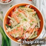 Kani salad with surimi, carrot, cucumber, sesame seeds + green onions, ready to serve.
