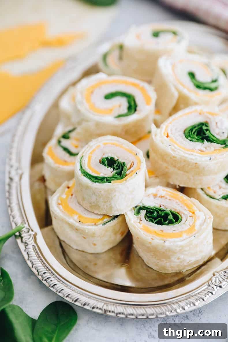 Swirl Bites 6 pinwheel sandwiches stacked on a silver platter