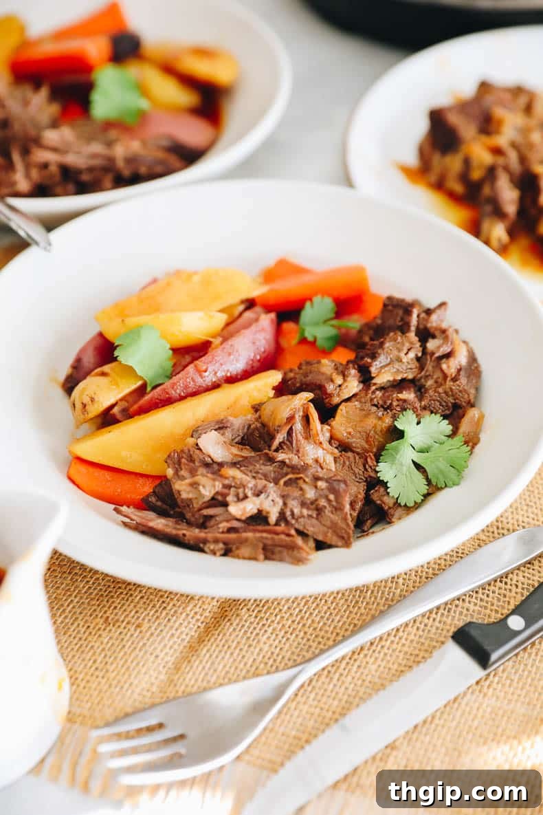 A perfectly cooked Instant Pot Pot Roast with rich gravy and vibrant vegetables, ready to serve.