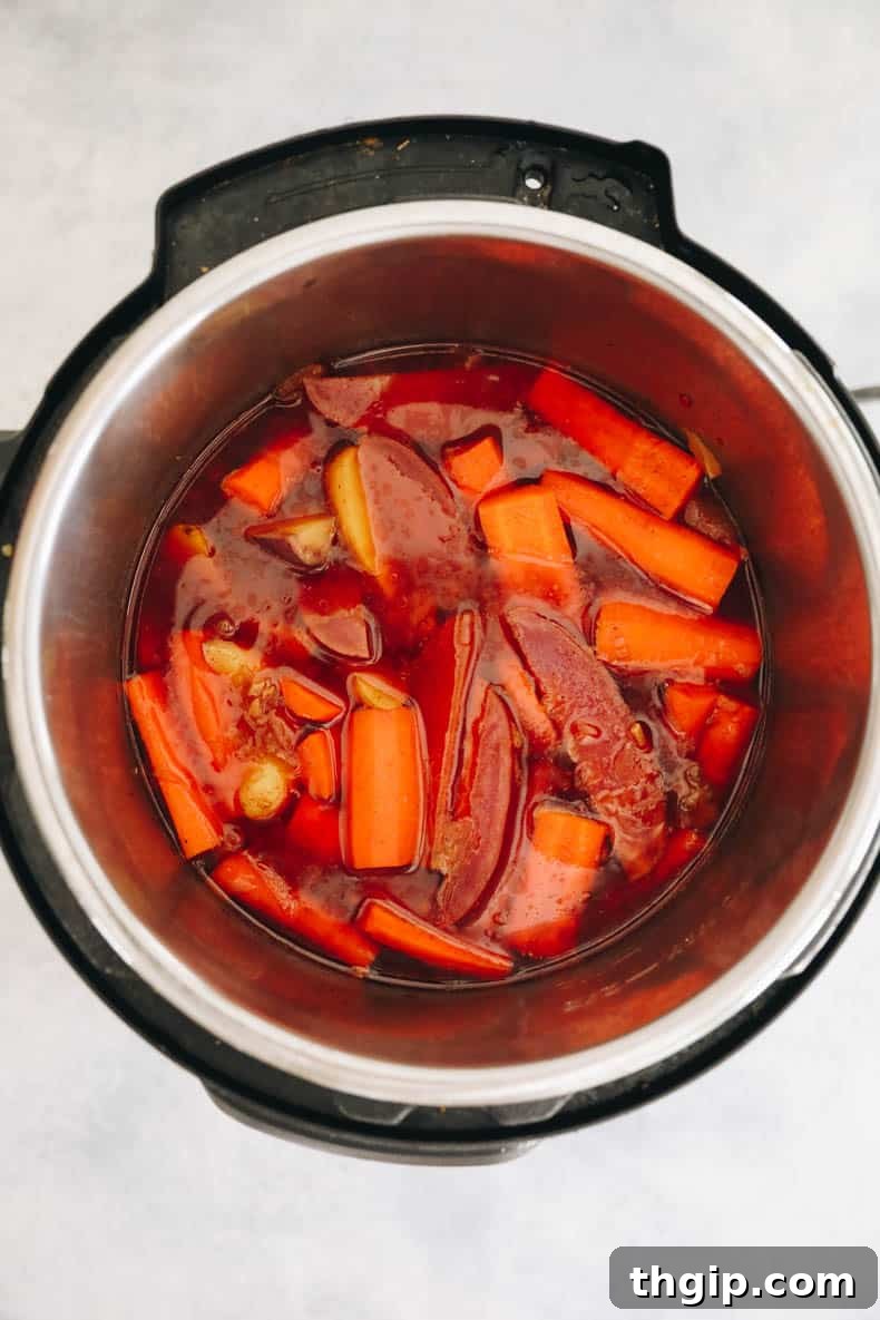 Vibrant carrots and potatoes cooked in the flavorful gravy in an Instant Pot.