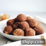 No need to fry anything with these baked pumpkin donut holes. Perfect for fall and made with healthier ingredients - including a #glutenfree option. #healthydessert #pumpkin #donutholes