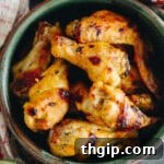 Baked Sriracha Lime Chicken Wings on a plate with fresh limes