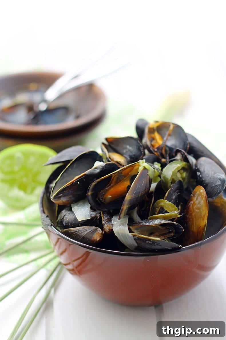 Close-up of vibrant Thai Curry Mussels in a serving bowl, ready to eat