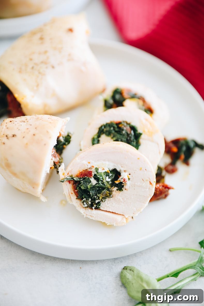 A final shot of the plated stuffed chicken with a side dish, garnished with fresh herbs.