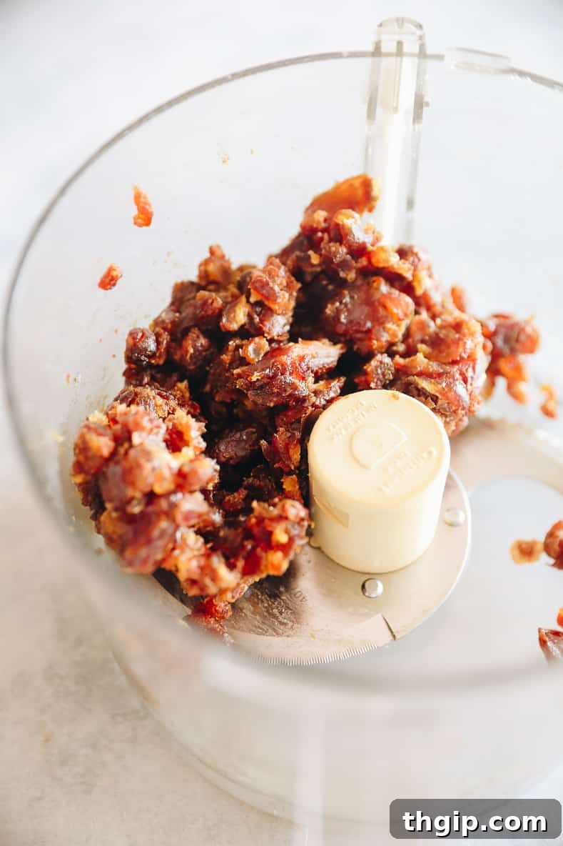 Coconut Almond Bliss Bites 4 Food processor with a date and nut mixture inside.