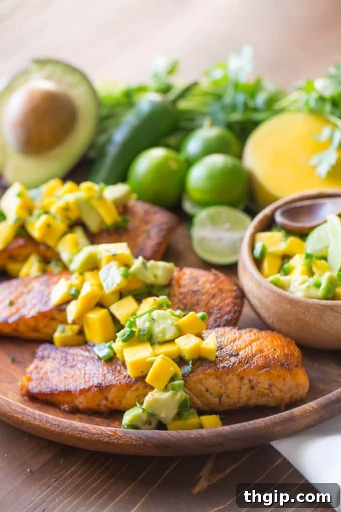 Chili Lime Salmon with Mango Avocado Salsa, served on a plate with fresh ingredients