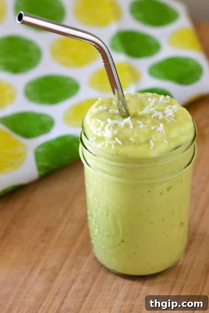 Creamy Avocado Mango Smoothie, a vibrant green and yellow drink in a glass