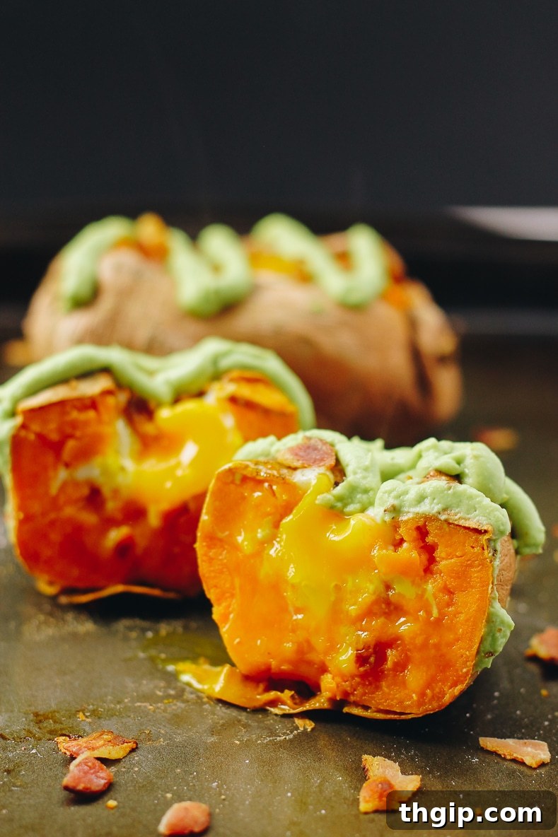 Hearty Sweet Potato Egg Boats with Creamy Avocado and Crispy Bacon 9 A close-up of a sweet potato egg boat with avocado crema and bacon, showing rich textures and colors.