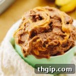 Scoops of Chocolate Peanut Butter Banana Ice Cream with a banana slice on top