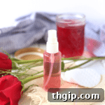 A simple jar of homemade rose water with petals inside