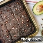 Close-up of a single avocado brownie, rich and dark.