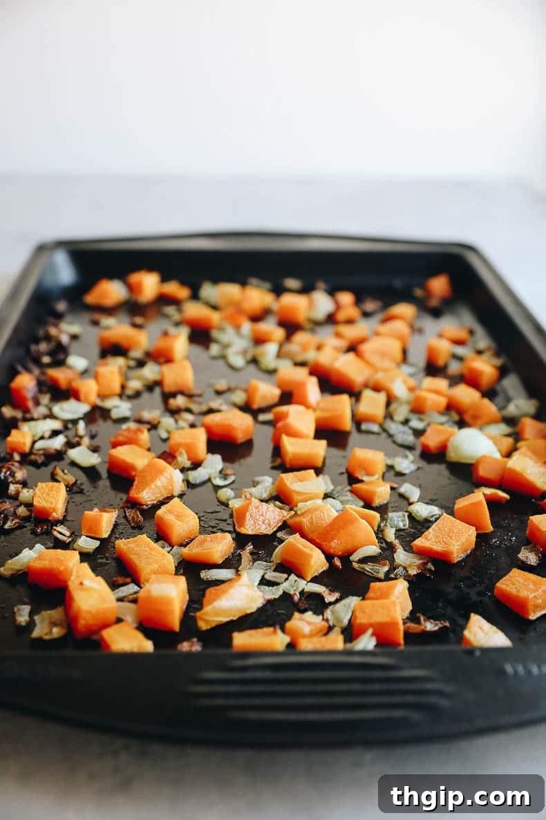 Cubed butternut squash roasted to perfection, ready for the wild rice pilaf