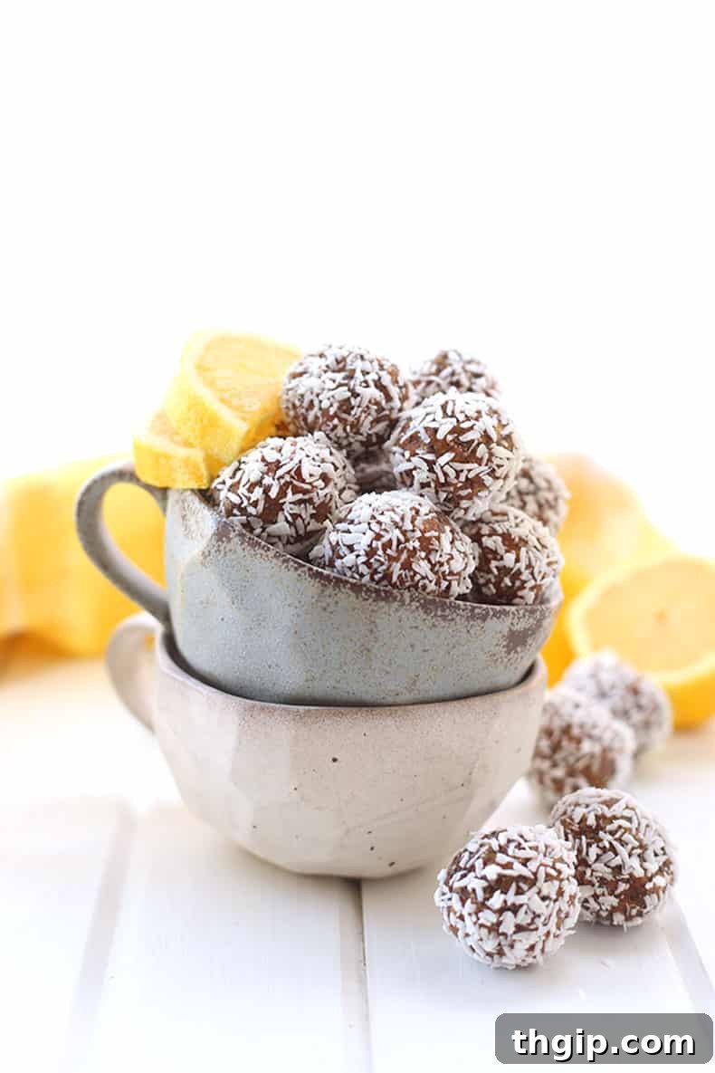 Zesty Coconut Energy Bites 2 Freshly prepared Lemon Coconut Energy Balls, coated in shredded coconut, ready to be enjoyed as a healthy snack.